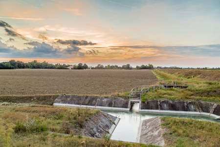 Channel to divert river water for irrigation of cultivated fieldsの写真素材