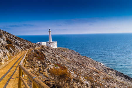 The lighthouse of Cape of Otranto in Apulia standing on hard granite rocks is the most easterly point of Italy and marks the meeting of the Ionian Sea and the Adriatic Seaの写真素材