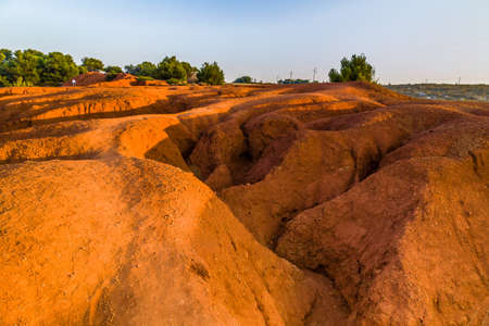 red soils around the freshwater lake formed in a former quarry for the extraction of bauxite in...
