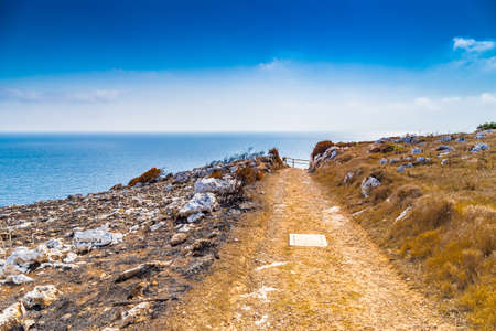 path on the steep rocks overlooking the sea in Apulia in Italyの写真素材