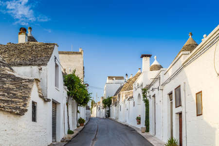 The Trulli of Alberobello in Apulia in Italy. These typical houses with dry stone walls and conical roofs are unique to the world and projecting this place outside of time and reality, somewhere between magic and historyの写真素材