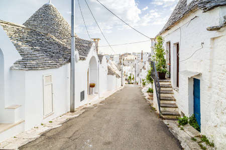 The Trulli of Alberobello in Apulia in Italy. These typical houses with dry stone walls and conical roofs are unique to the world and projecting this place outside of time and reality, somewhere between magic and historyの写真素材