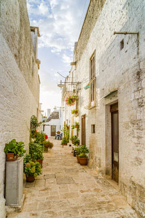 The Trulli of Alberobello in Apulia in Italy. These typical houses with dry stone walls and conical roofs are unique to the world and projecting this place outside of time and reality, somewhere between magic and historyの写真素材