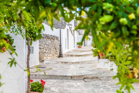 The Trulli of Alberobello in Apulia in Italy. These typical houses with dry stone walls and conical roofs are unique to the world and projecting this place outside of time and reality, somewhere between magic and historyの写真素材