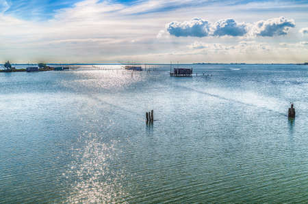 fishing huts with balance netfish in the lagoon of the valleys of Comacchio in Emilia Romagnaの写真素材