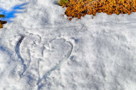 broken heart drawn in the snowの写真素材