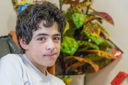 Caucasian teenage boy waits in the waiting room in the medical officeの写真素材