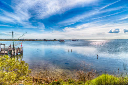 fishing huts with balance netfish in the lagoon of the valleys of Comacchio in Emilia Romagnaの写真素材