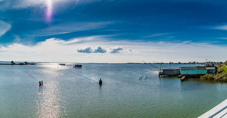 fishing huts with balance netfish in the lagoon of the valleys of Comacchio in Emilia Romagnaの写真素材