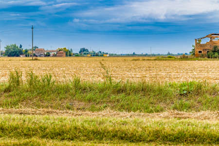 soil after harvest near irrigation canalの写真素材