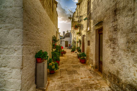 The Trulli of Alberobello in Apulia in Italy. These typical houses with dry stone walls and conical roofs are unique to the world and projecting this place outside of time and reality, somewhere between magic and historyの写真素材