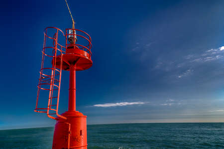 red lighthouse on a pier on  the Adriatic Seaの写真素材