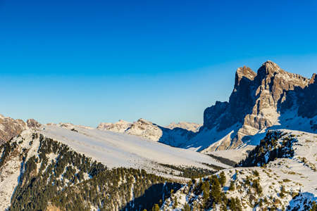 panorama of the Dolomites with snow-capped peaks and conifersの写真素材