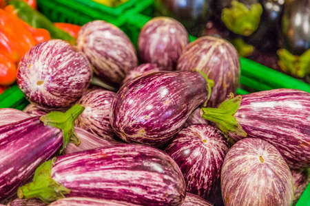striped eggplant in green box for sale on the vegetable counterの写真素材