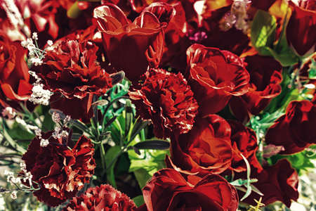 fake laminated paper flowers in a cemeteryの写真素材