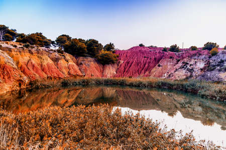 red soils around the freshwater lake formed in a former quarry for the extraction of bauxite in...