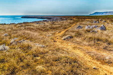 red path on the rocky beach near Otranto in Apulia, Italyの写真素材