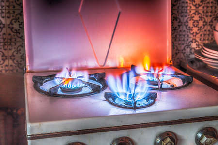old encrusted gas stove with three firesの写真素材