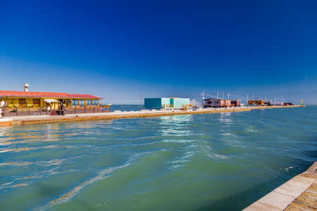 fishing huts with fishing net with balance on prefabricated pier of a small town on the Adriatic coastの写真素材
