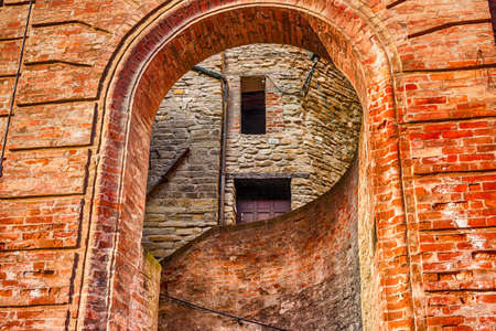 Round entry to alley  of Brisighella, hill village in Emilia Romagna in Italyの写真素材