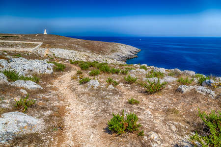 the watch tower of the serpent, symbol of Otranto, on the rocky beach near Otranto in Apulia, Italyの写真素材