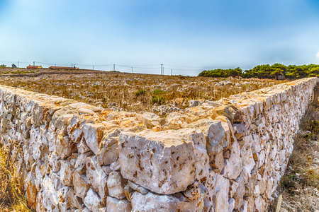 wall on the rocky beach near Otranto in Apulia, Italy