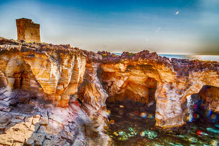 Watchtower overlooking amazing natural pool surrounded only by the Adriatic  sea or by caves in Italy,  Marina Serra Tricase, Lecce, Apuliaの写真素材