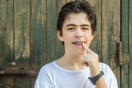 teenager with acne skin smiling while showing braces