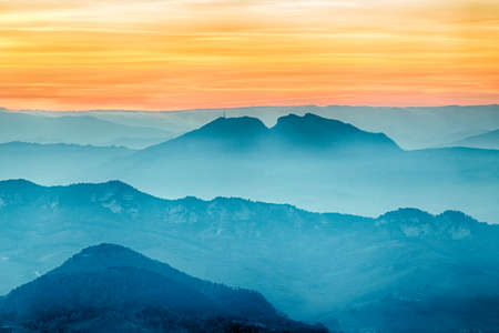 sunset on hilltops in the mist around Titan Mount in the Repubblic of San Marino