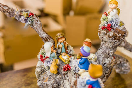 vivid colors of a Christmas Nativity scene, the Blessed Virgin Mary and Saint Joseph watch over the Holy Child Jesus in a manger as the ox and the donkey are warmingの写真素材