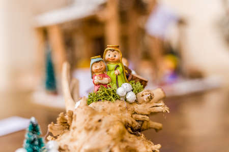 vivid colors of a Christmas Nativity scene, the Blessed Virgin Mary and Saint Joseph watch over the Holy Child Jesus in a mangerの写真素材