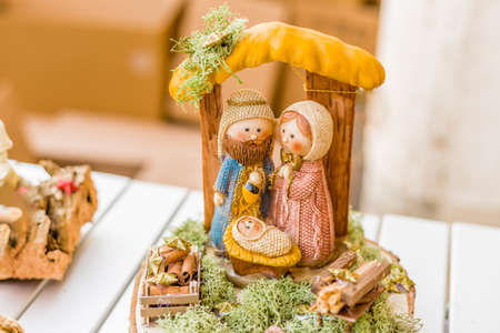 vivid colors of a Christmas Nativity scene, the Blessed Virgin Mary and Saint Joseph watch over the Holy Child Jesus in a mangerの写真素材