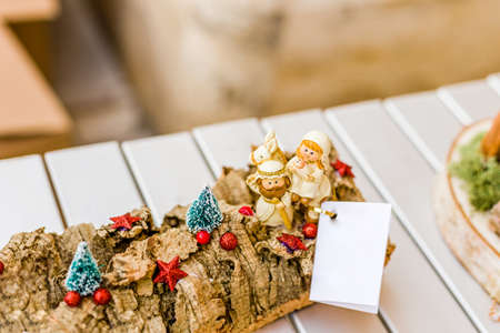 vivid colors of a Christmas Nativity scene, the Blessed Virgin Mary and Saint Joseph watch over the Holy Child Jesus in a mangerの写真素材