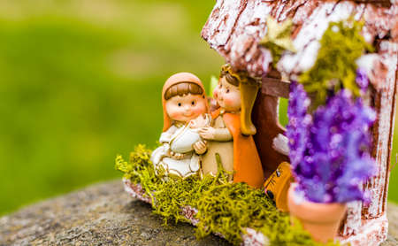 vivid colors of a Christmas Nativity scene, the Blessed Virgin Mary and Saint Joseph watch over the...
