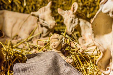 Statues in a Christmas Nativity scene, the Blessed Virgin Mary and Saint Joseph watch over the Holy...