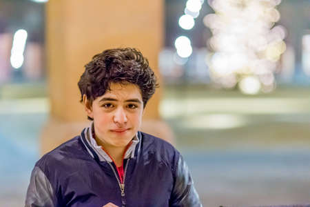 close portrait of Caucasian boy with reassuring look in warm and bright ambianceの写真素材