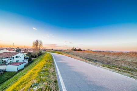 road along the roofs of the houses of a small village in the countryside of Emilia Romagna in Italyの写真素材