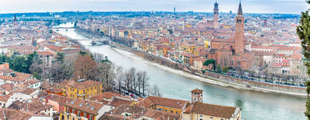 panorama of the Adige River as it passes through the houses and historical buildings of Verona in Italy, known as romantic city of love because Romeo and Juliet by Shakespeare was set hereの写真素材