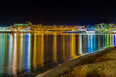 Night view of harbor of ancient city on the Adriatic Sea in Italyの写真素材
