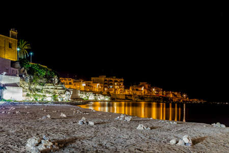 Night view of harbor of ancient city on the Adriatic Sea in Italyの写真素材