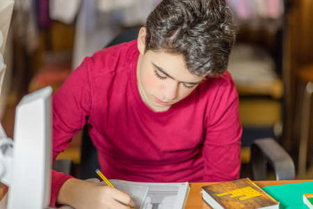caucasian boy doing homeworks