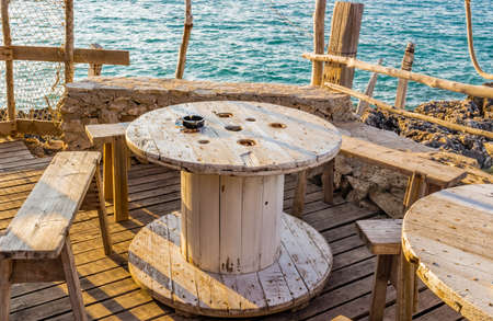 rustic tables on the coast of Puglia in Italyの写真素材