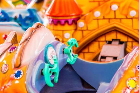 close up of merry-go-round seats, fake cars steeringの写真素材