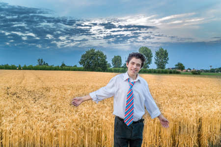 cute caucasian boy in a wheat field in countrysideの写真素材