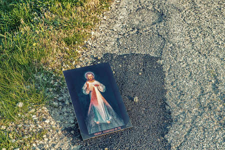 the Merciful Jesus iconon dirt asphalt road, italian sentence written on the bottom meaning Jesus I trust in Youの写真素材
