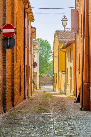 cobbled street that runs between the old buildings of an Italian medieval villageの写真素材