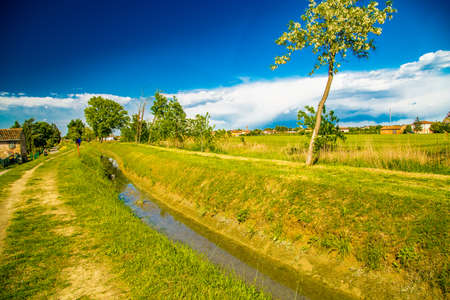 channel with drainage and irrigation water  in the countryside of Romagna in Italyの写真素材
