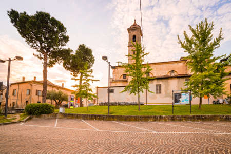 parking lot paved with cobblestones behind the church in a medieval villageの写真素材