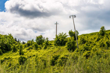 crooked pylons in a green countrysideの写真素材