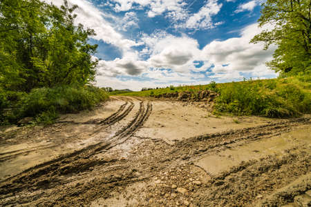 ruts in the mud on the dirt road left by tractor on the Apennines hills of Tuscany and Romagnaの写真素材